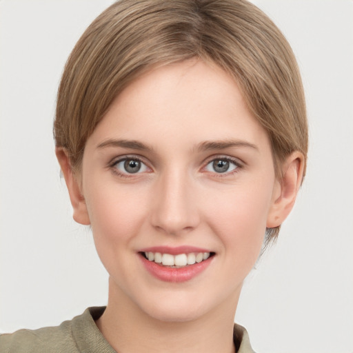 Joyful white young-adult female with short  brown hair and grey eyes