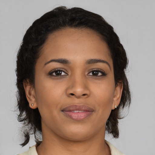 Joyful latino young-adult female with medium  brown hair and brown eyes