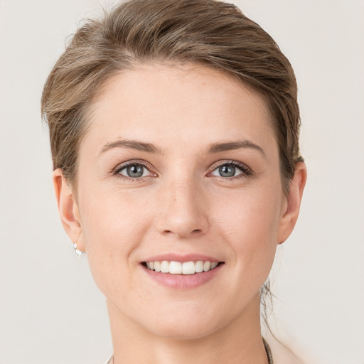 Joyful white young-adult female with short  brown hair and grey eyes