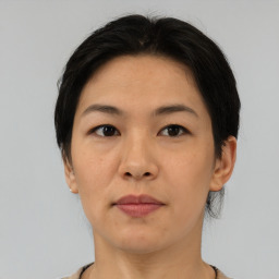 Neutral asian adult female with medium  brown hair and brown eyes