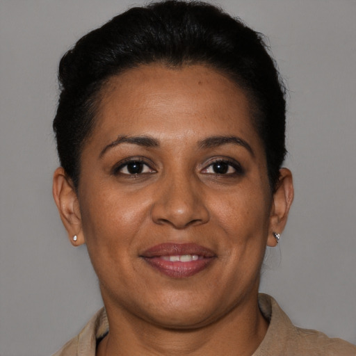 Joyful latino young-adult female with short  brown hair and brown eyes