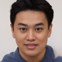 Joyful asian young-adult male with short  brown hair and brown eyes