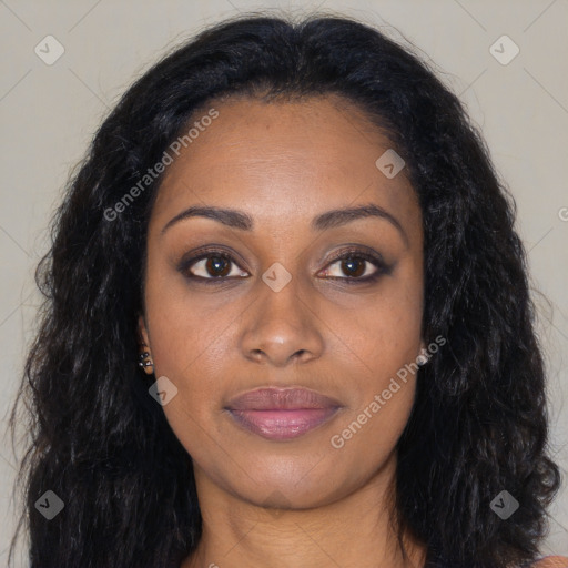 Joyful black young-adult female with long  black hair and brown eyes