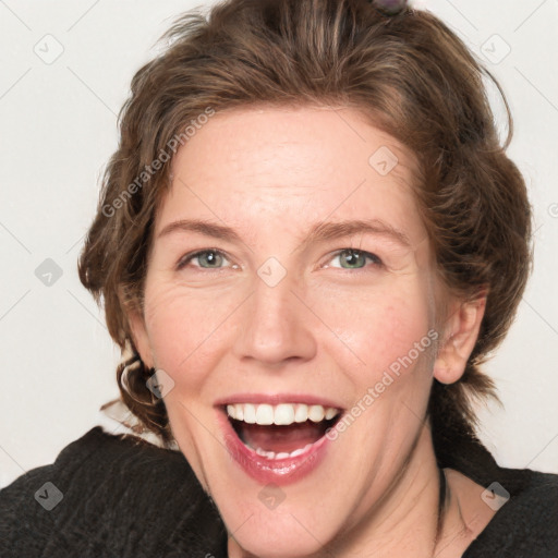 Joyful white adult female with medium  brown hair and green eyes