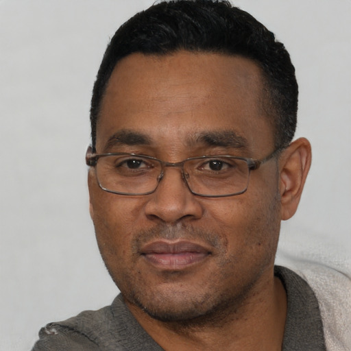 Neutral black adult male with short  black hair and brown eyes