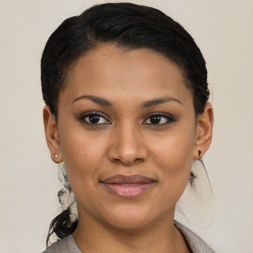 Joyful latino young-adult female with short  brown hair and brown eyes