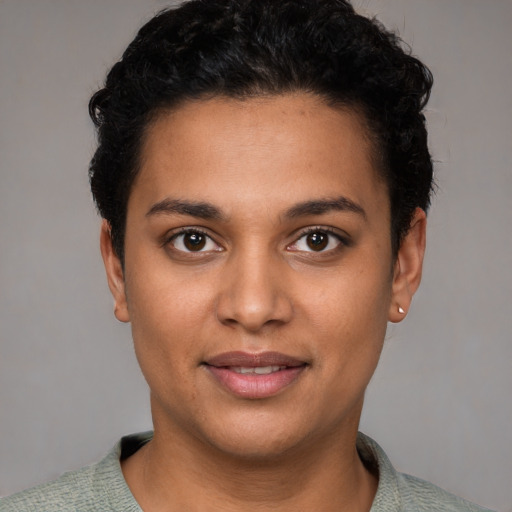 Joyful latino young-adult female with short  brown hair and brown eyes