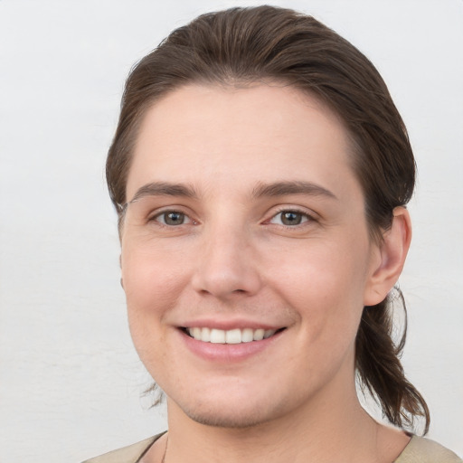 Joyful white young-adult female with short  brown hair and grey eyes