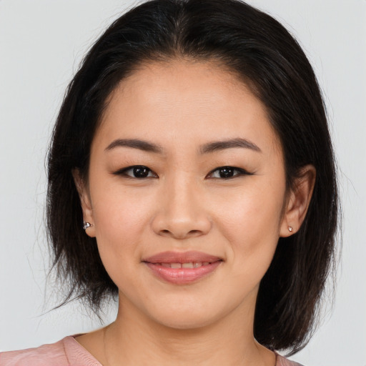 Joyful asian young-adult female with medium  brown hair and brown eyes