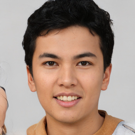 Joyful asian young-adult male with short  black hair and brown eyes