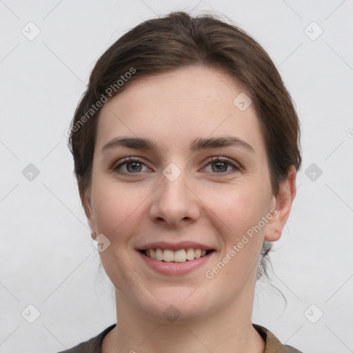 Joyful white young-adult female with short  brown hair and grey eyes