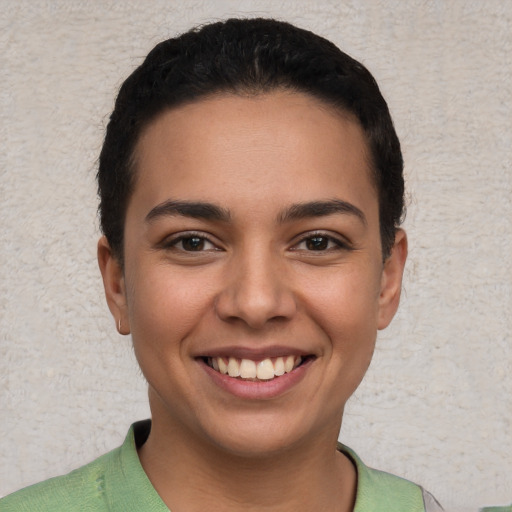 Joyful white young-adult female with short  black hair and brown eyes