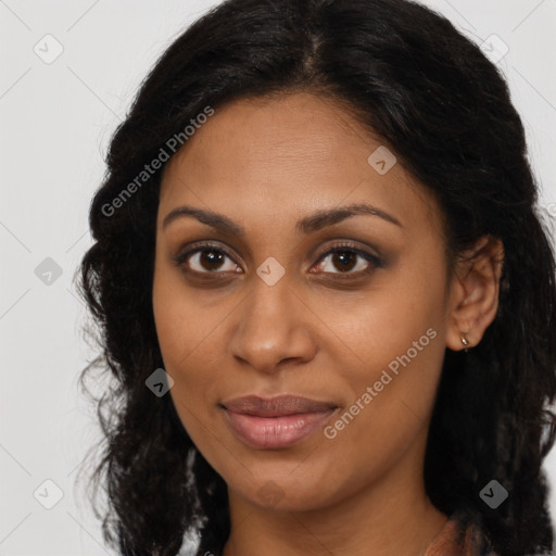 Joyful black young-adult female with long  brown hair and brown eyes