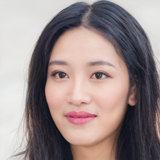 Joyful white young-adult female with long  black hair and brown eyes