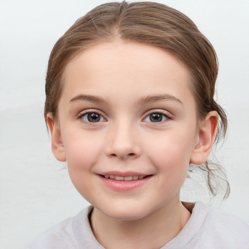 Joyful white child female with medium  brown hair and grey eyes