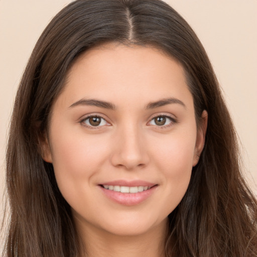 Joyful white young-adult female with long  brown hair and brown eyes