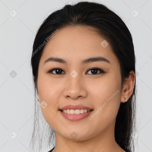 Joyful asian young-adult female with long  brown hair and brown eyes