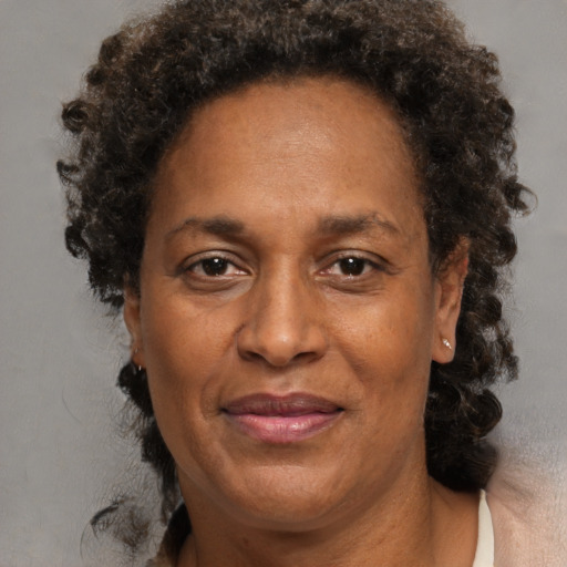 Joyful black adult female with medium  brown hair and brown eyes