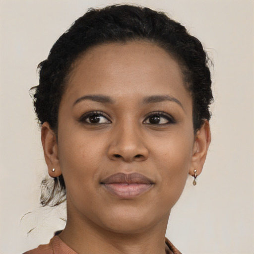 Joyful black young-adult female with short  brown hair and brown eyes