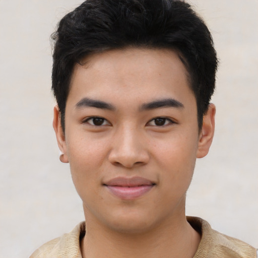 Joyful asian young-adult male with short  brown hair and brown eyes