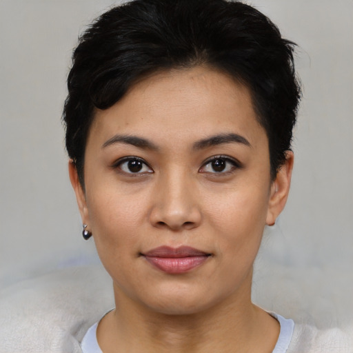 Joyful asian young-adult female with short  black hair and brown eyes