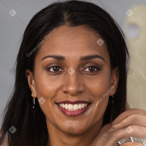 Joyful latino young-adult female with long  brown hair and brown eyes