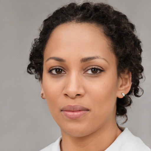 Joyful black young-adult female with medium  brown hair and brown eyes