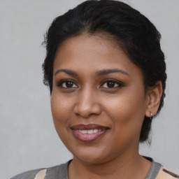 Joyful black young-adult female with medium  brown hair and brown eyes