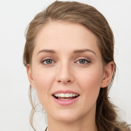 Joyful white young-adult female with medium  brown hair and grey eyes