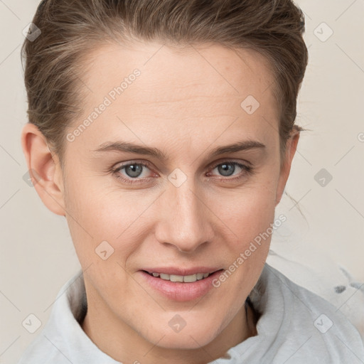 Joyful white young-adult female with short  brown hair and blue eyes