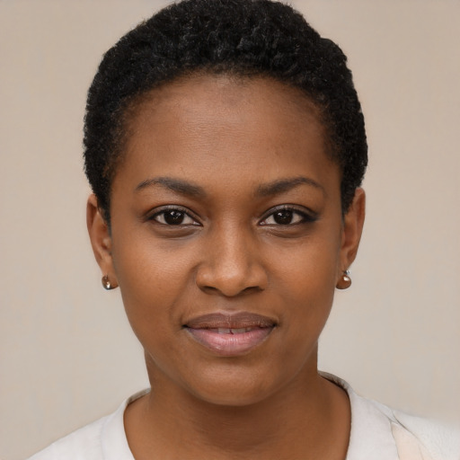 Joyful black young-adult female with short  black hair and brown eyes