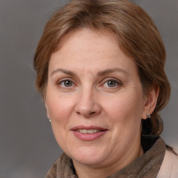 Joyful white adult female with medium  brown hair and grey eyes