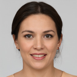 Joyful white young-adult female with medium  brown hair and grey eyes