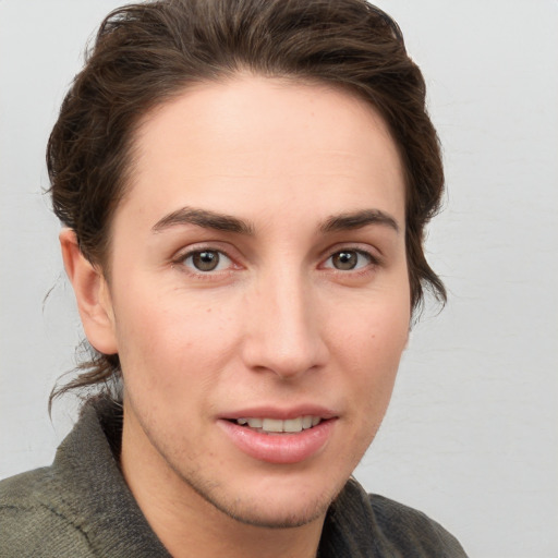 Joyful white young-adult female with short  brown hair and grey eyes