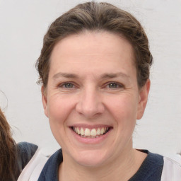 Joyful white adult female with medium  brown hair and brown eyes