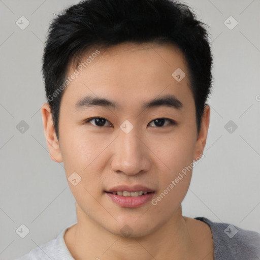 Joyful asian young-adult male with short  black hair and brown eyes