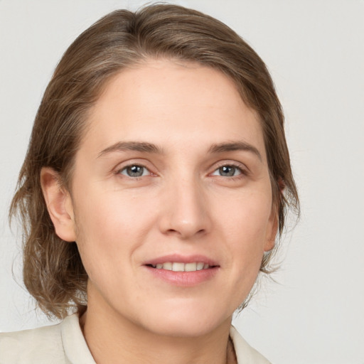 Joyful white young-adult female with medium  brown hair and grey eyes