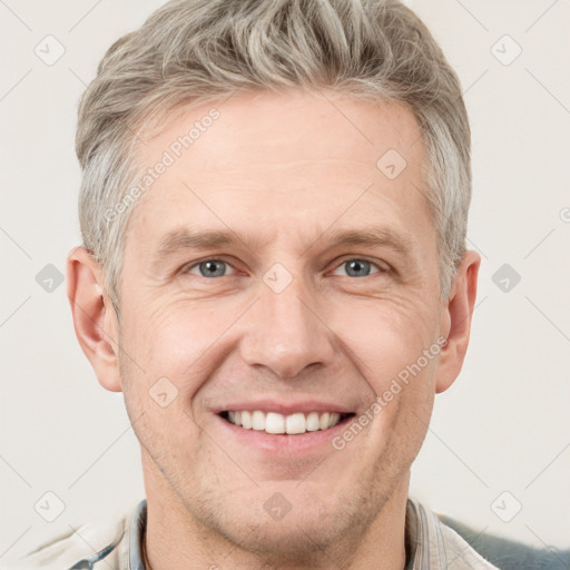 Joyful white adult male with short  brown hair and grey eyes