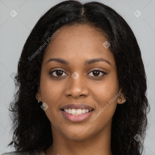 Joyful black young-adult female with long  black hair and brown eyes