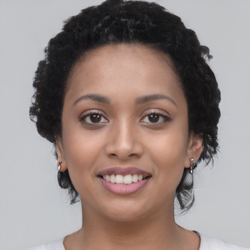 Joyful latino young-adult female with medium  black hair and brown eyes
