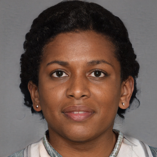 Joyful black young-adult female with short  brown hair and brown eyes