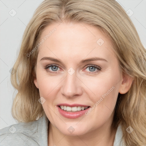 Joyful white adult female with medium  brown hair and blue eyes