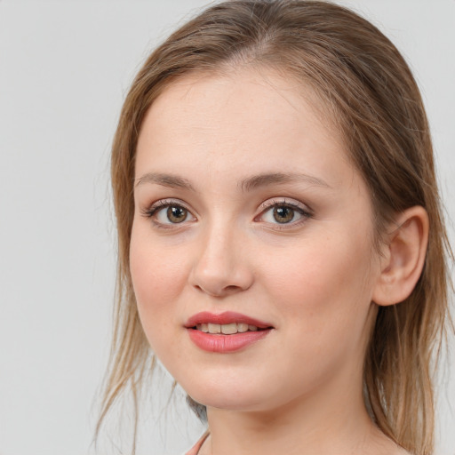 Joyful white young-adult female with medium  brown hair and blue eyes