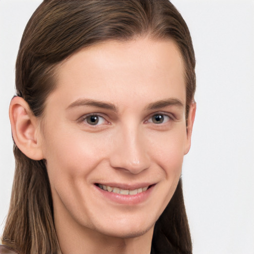 Joyful white young-adult female with long  brown hair and grey eyes