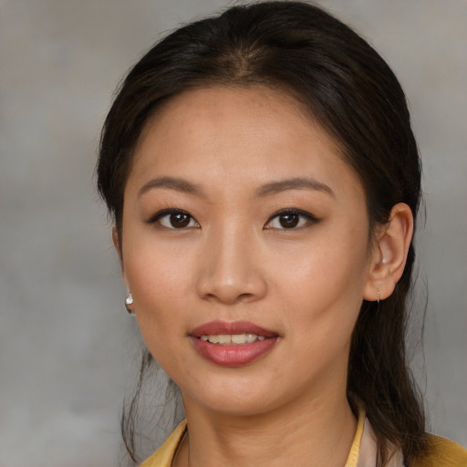 Joyful asian young-adult female with medium  brown hair and brown eyes