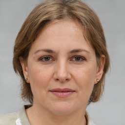 Joyful white adult female with medium  brown hair and brown eyes