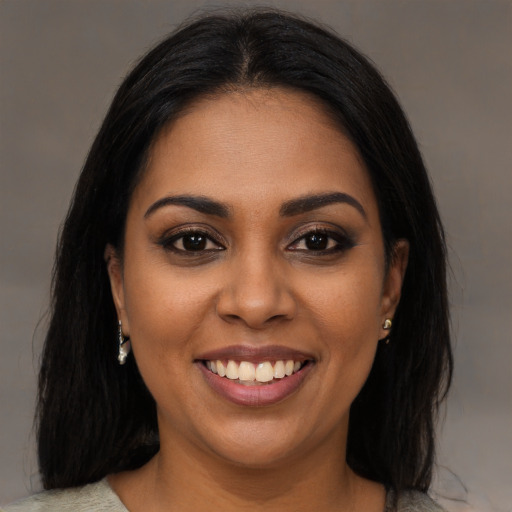 Joyful black young-adult female with medium  brown hair and brown eyes