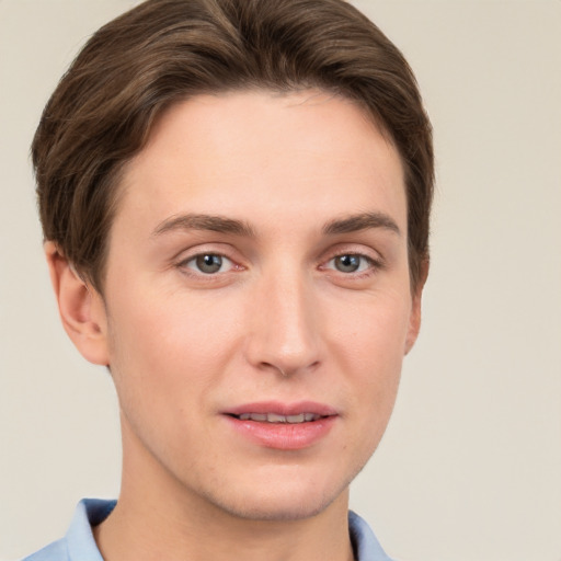 Joyful white young-adult female with short  brown hair and grey eyes