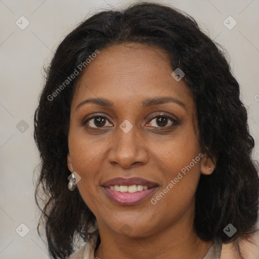 Joyful black adult female with medium  brown hair and brown eyes