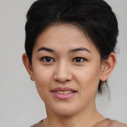 Joyful asian young-adult female with medium  brown hair and brown eyes